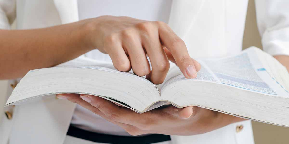 person reading the code of professional ethics from book